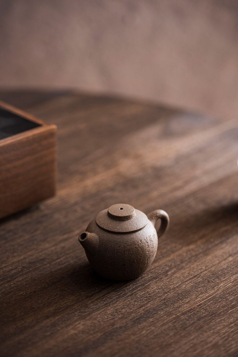 Small wooden teapot on a cozy table — symbolizing calm, daily rituals, and the power of tiny shifts for big change.